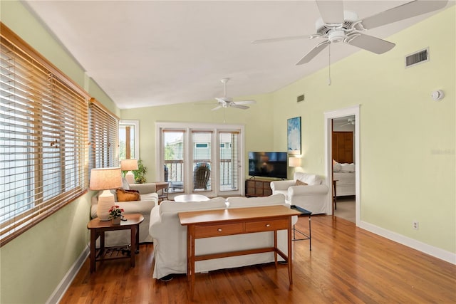6956 Turtlemound Rd, New Smyrna Beach, FL 32169 - living room featuring wood finished floors, vaulted ceiling, and ceiling fan