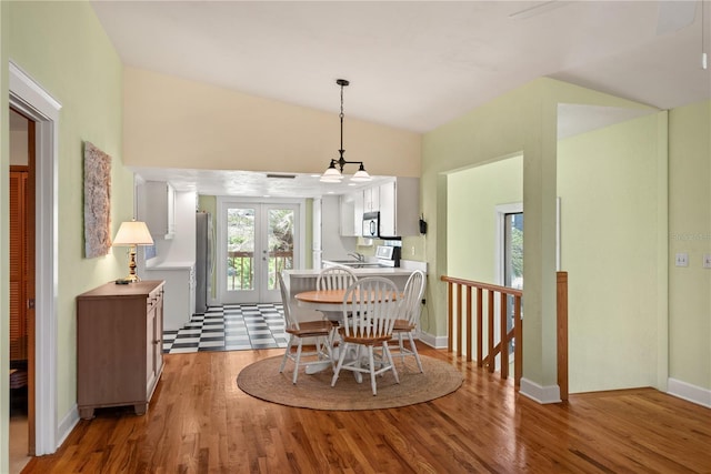6956 Turtlemound Rd, New Smyrna Beach, FL 32169 - dining room featuring wood finished floors, lofted ceiling, and a chandelier