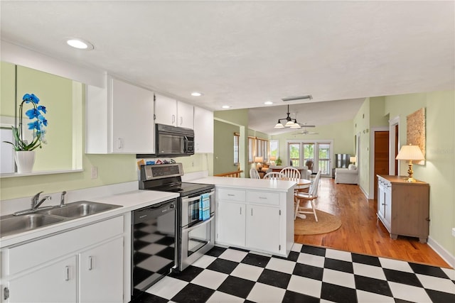 6956 Turtlemound Rd, New Smyrna Beach, FL 32169 - kitchen featuring black appliances, light flooring, a peninsula, open floor plan, and light countertops