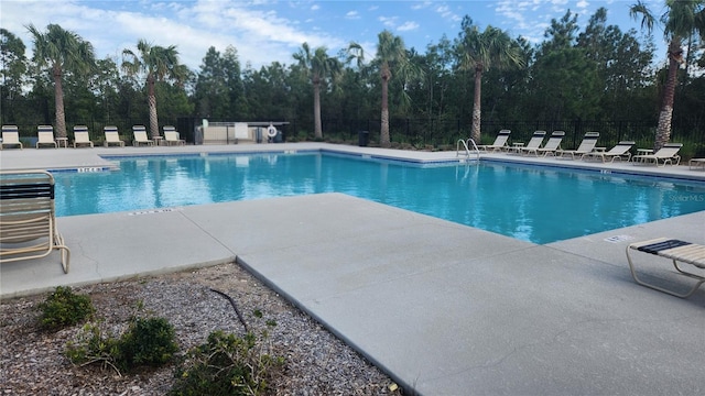 3103 Nova Scotia Way, New Smyrna Beach, FL 32168 - community pool featuring a patio area and view of wooded area
