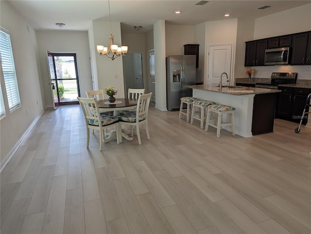 3103 Nova Scotia Way, New Smyrna Beach, FL 32168 - dining room with a chandelier, light wood-style flooring, and recessed lighting