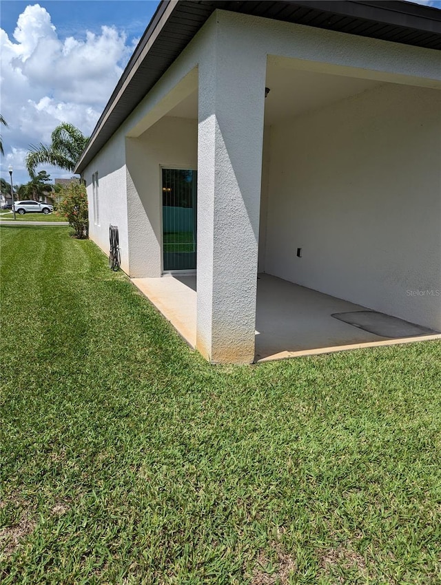 3103 Nova Scotia Way, New Smyrna Beach, FL 32168 - view of home's exterior with stucco siding, a lawn, and a patio area
