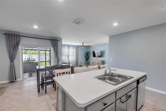 2731 Neverland Dr, New Smyrna Beach, FL 32168 - kitchen with dishwasher, gray cabinets, light tile patterned flooring, light countertops, and an island with sink