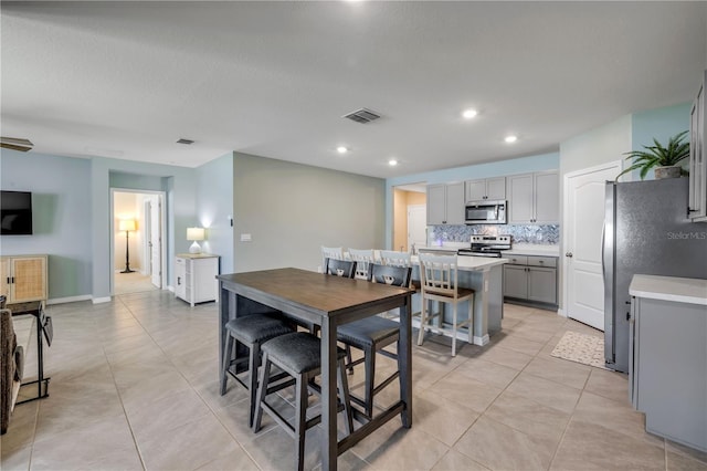 2731 Neverland Dr, New Smyrna Beach, FL 32168 - dining area with light tile patterned floors and recessed lighting