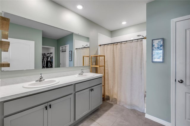 2731 Neverland Dr, New Smyrna Beach, FL 32168 - bathroom featuring double vanity, tile patterned floors, curtained shower, and a walk in closet