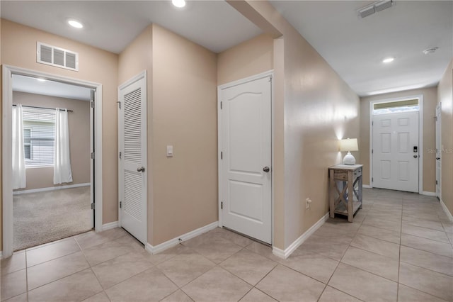 2731 Neverland Dr, New Smyrna Beach, FL 32168 - foyer with light tile patterned floors and recessed lighting