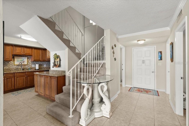 901 S Atlantic Ave Unit 202, Ormond Beach, FL 32176 - foyer featuring light tile patterned floors, a textured ceiling, and stairs