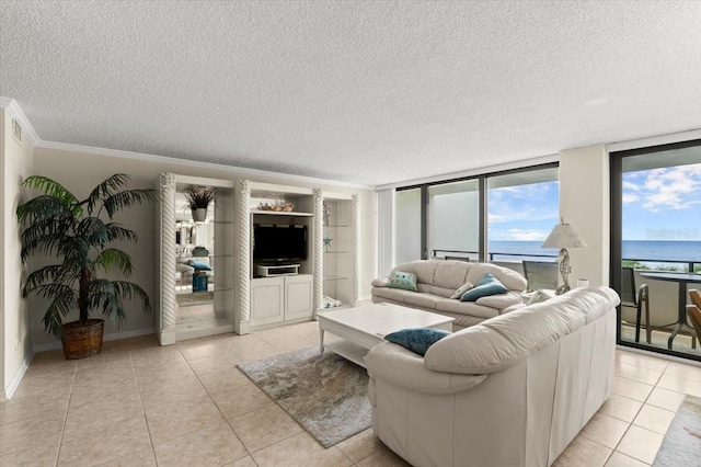 901 S Atlantic Ave Unit 202, Ormond Beach, FL 32176 - living room featuring light tile patterned flooring, a textured ceiling, and crown molding