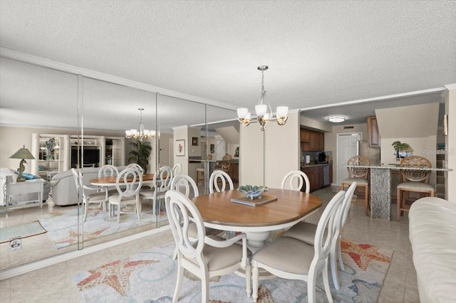 901 S Atlantic Ave Unit 202, Ormond Beach, FL 32176 - dining room with a chandelier, crown molding, light tile patterned flooring, and a textured ceiling