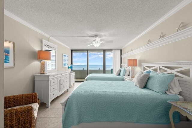 901 S Atlantic Ave Unit 202, Ormond Beach, FL 32176 - bedroom featuring access to exterior, a textured ceiling, a water view, ornamental molding, and light tile patterned flooring