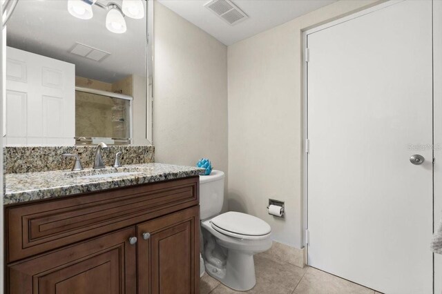 901 S Atlantic Ave Unit 202, Ormond Beach, FL 32176 - bathroom featuring tile patterned floors, a stall shower, and vanity