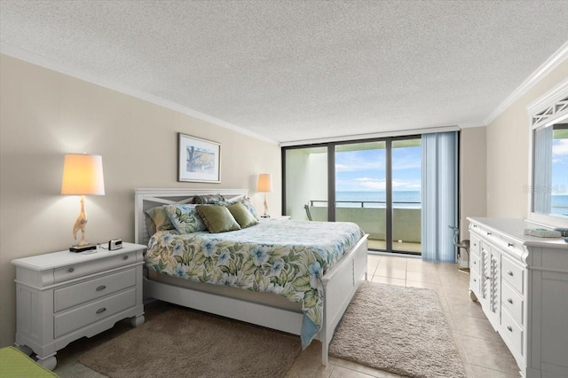 901 S Atlantic Ave Unit 202, Ormond Beach, FL 32176 - bedroom featuring access to exterior, ornamental molding, a textured ceiling, light tile patterned floors, and a water view