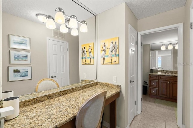 901 S Atlantic Ave Unit 202, Ormond Beach, FL 32176 - bathroom featuring tile patterned floors, vanity, and a textured ceiling