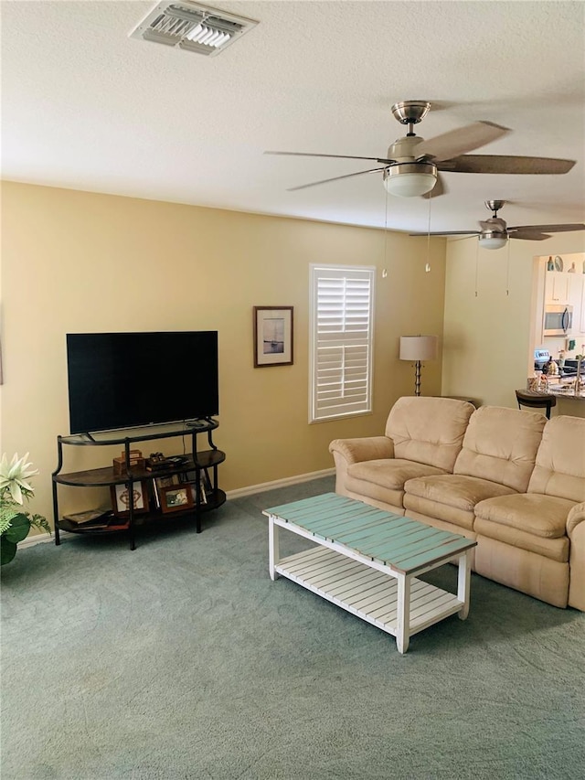 2672 Star Coral Ln, New Smyrna Beach, FL 32168 - carpeted living room with ceiling fan and a textured ceiling