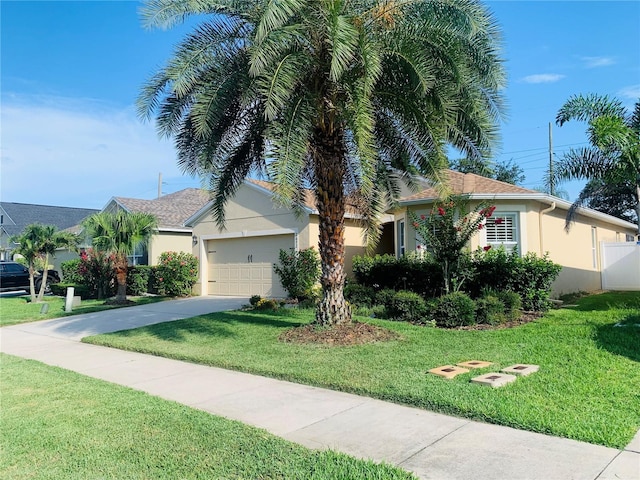 2672 Star Coral Ln, New Smyrna Beach, FL 32168 - view of front of home with stucco siding, concrete driveway, and a garage