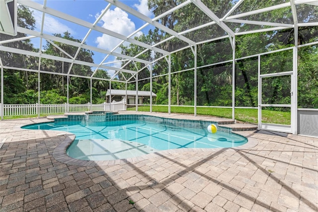 2360 Mooneyham Dr, New Smyrna Beach, FL 32168 - view of pool with a patio, glass enclosure, a pool with connected hot tub, and view of wooded area
