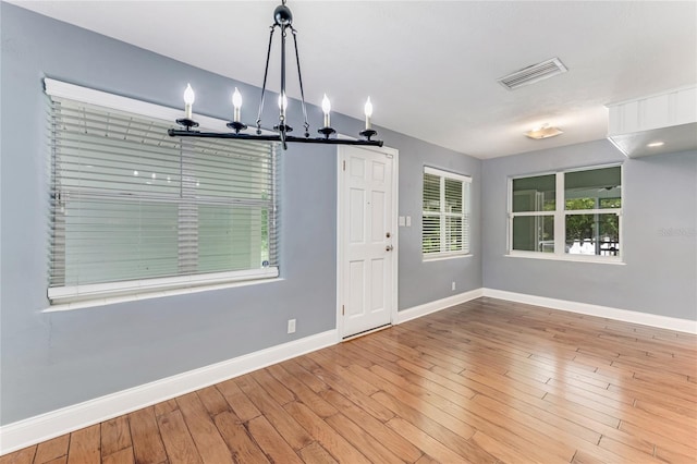 2360 Mooneyham Dr, New Smyrna Beach, FL 32168 - unfurnished dining area with a chandelier and wood finished floors