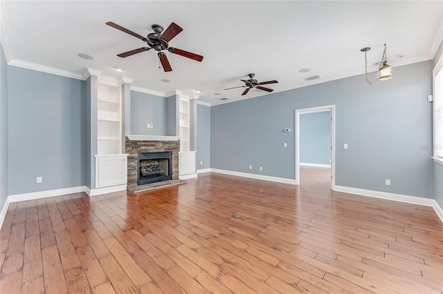 2360 Mooneyham Dr, New Smyrna Beach, FL 32168 - unfurnished living room with a ceiling fan, ornamental molding, light wood-type flooring, and a fireplace