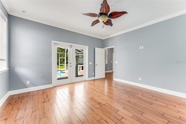 2360 Mooneyham Dr, New Smyrna Beach, FL 32168 - empty room with ceiling fan, light wood-style floors, ornamental molding, french doors, and a smoke detector
