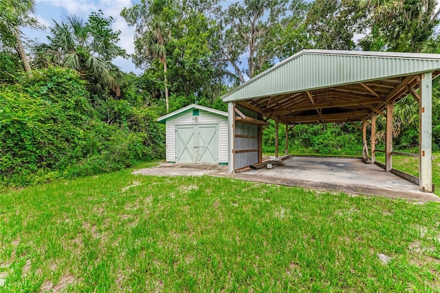 2360 Mooneyham Dr, New Smyrna Beach, FL 32168 - view of grassy yard with a storage unit and driveway