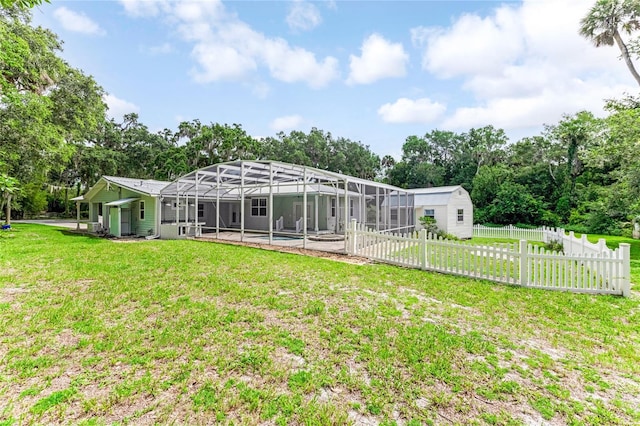 2360 Mooneyham Dr, New Smyrna Beach, FL 32168 - rear view of property featuring a lanai, view of wooded area, and a storage unit