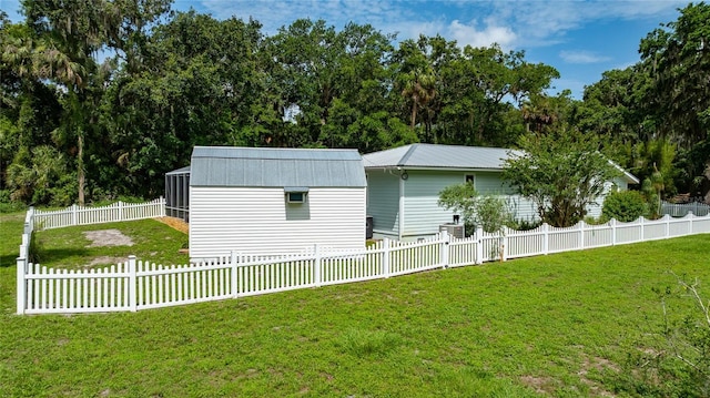 2360 Mooneyham Dr, New Smyrna Beach, FL 32168 - view of side of property featuring a fenced backyard and a metal roof