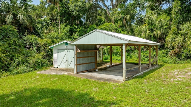 2360 Mooneyham Dr, New Smyrna Beach, FL 32168 - view of home's community with a lawn, a detached carport, and a storage shed