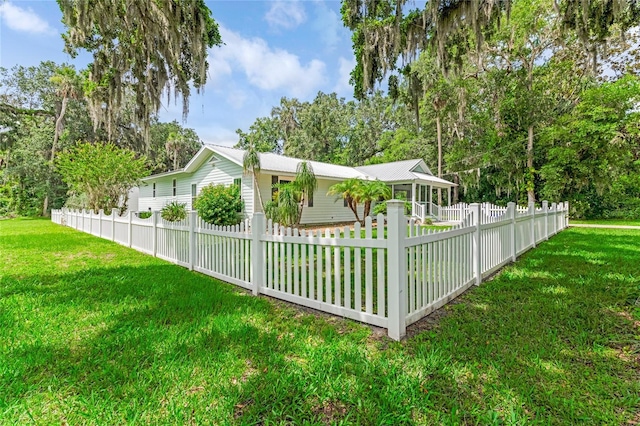 2360 Mooneyham Dr, New Smyrna Beach, FL 32168 - view of side of home with a fenced front yard and a metal roof