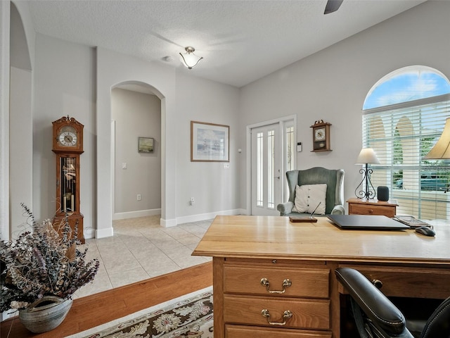 461 Luna Bella Ln, New Smyrna Beach, FL 32168 - office area with arched walkways, light tile patterned flooring, a textured ceiling, and ceiling fan