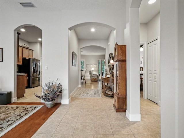 461 Luna Bella Ln, New Smyrna Beach, FL 32168 - hallway with light tile patterned flooring and recessed lighting