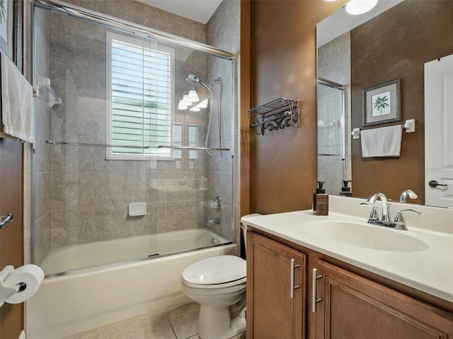 461 Luna Bella Ln, New Smyrna Beach, FL 32168 - full bathroom featuring vanity, bath / shower combo with glass door, tile patterned flooring, and a textured wall