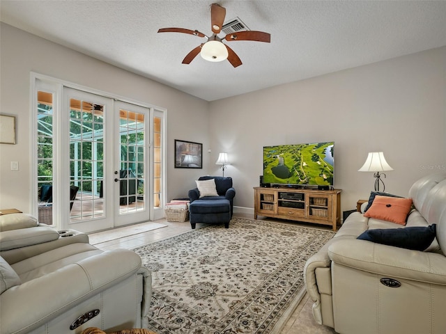 461 Luna Bella Ln, New Smyrna Beach, FL 32168 - living area featuring french doors, a ceiling fan, a textured ceiling, and tile patterned flooring