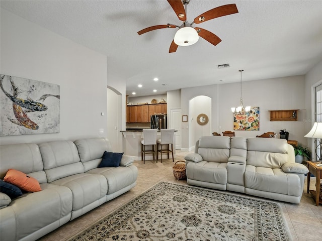 461 Luna Bella Ln, New Smyrna Beach, FL 32168 - living room featuring arched walkways, light tile patterned flooring, ceiling fan, recessed lighting, and a chandelier