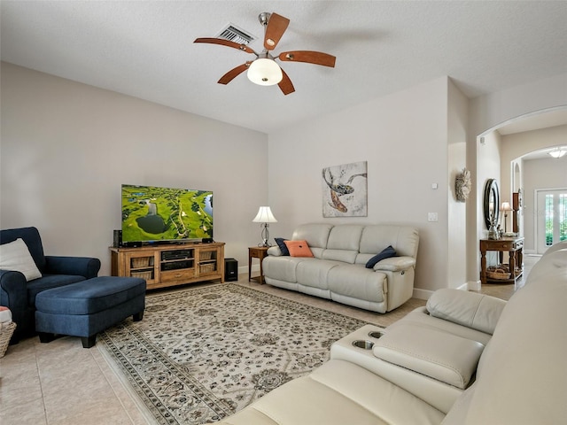 461 Luna Bella Ln, New Smyrna Beach, FL 32168 - living area with arched walkways, ceiling fan, and light tile patterned flooring