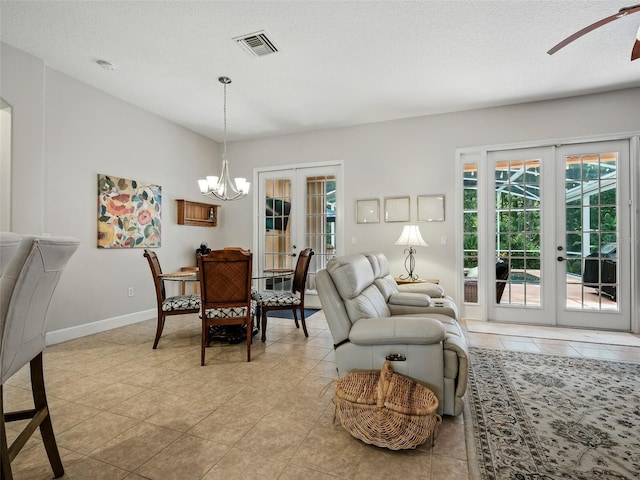 461 Luna Bella Ln, New Smyrna Beach, FL 32168 - living room featuring french doors, plenty of natural light, and a chandelier