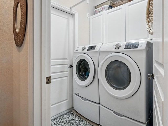 461 Luna Bella Ln, New Smyrna Beach, FL 32168 - washroom featuring washer and clothes dryer, cabinet space, and light tile patterned floors