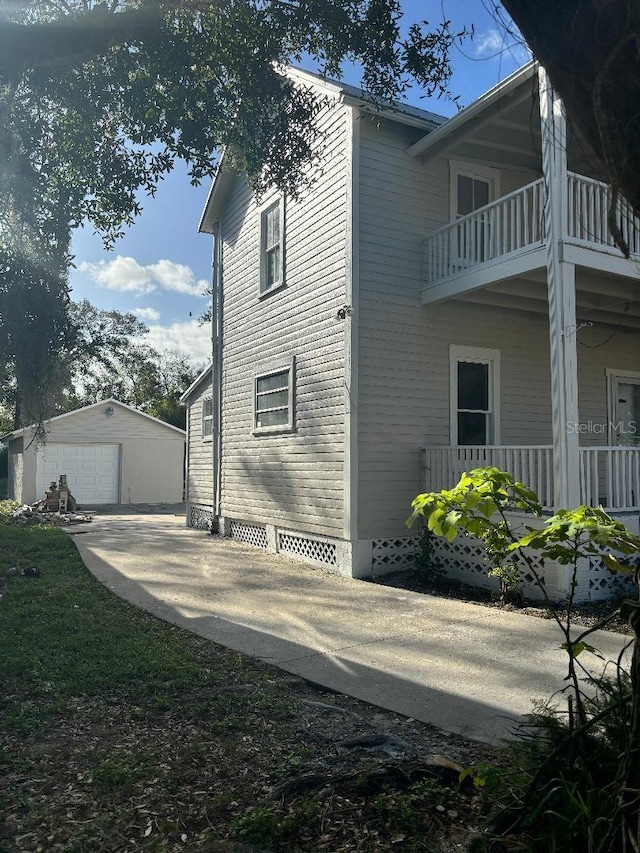 306 Murray St, New Smyrna Beach, FL 32168 - view of home's exterior with a balcony, a garage, and an outbuilding