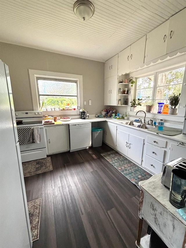 306 Murray St, New Smyrna Beach, FL 32168 - kitchen featuring white appliances, light countertops, white cabinets, dark wood-type flooring, and open shelves