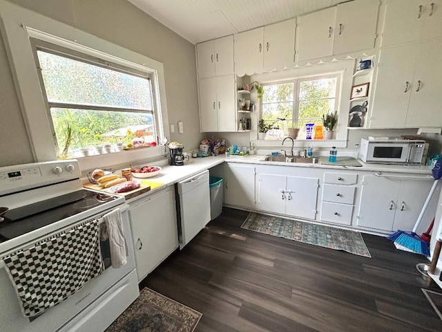 306 Murray St, New Smyrna Beach, FL 32168 - kitchen featuring white appliances, light countertops, dark wood-type flooring, and white cabinets