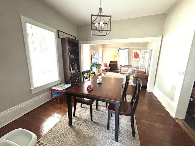 306 Murray St, New Smyrna Beach, FL 32168 - dining room with wood finished floors and a chandelier