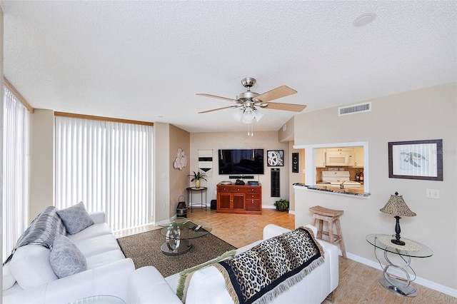 1 Oceans W Blvd Unit 1B5, Daytona Beach, FL 32118 - living area featuring ceiling fan, light wood-type flooring, and a textured ceiling