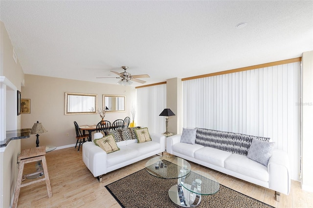 1 Oceans W Blvd Unit 1B5, Daytona Beach, FL 32118 - living room with a ceiling fan, light wood-style floors, and a textured ceiling