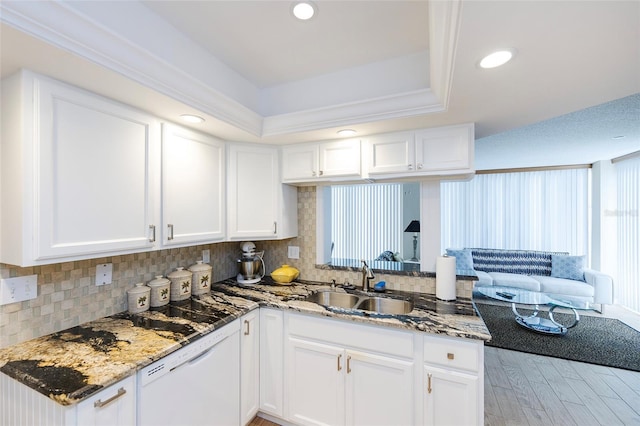 1 Oceans W Blvd Unit 1B5, Daytona Beach, FL 32118 - kitchen featuring dishwasher, a raised ceiling, white cabinets, light stone countertops, and recessed lighting