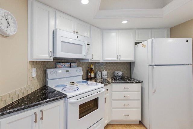 1 Oceans W Blvd Unit 1B5, Daytona Beach, FL 32118 - kitchen with white appliances, dark stone counters, white cabinetry, tasteful backsplash, and recessed lighting