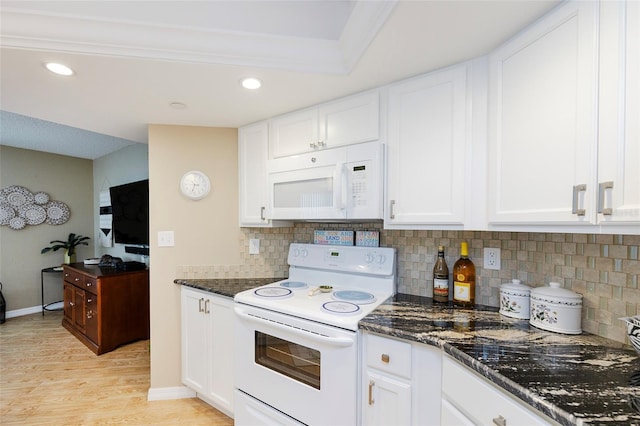 1 Oceans W Blvd Unit 1B5, Daytona Beach, FL 32118 - kitchen with white appliances, light wood-style flooring, decorative backsplash, white cabinetry, and recessed lighting