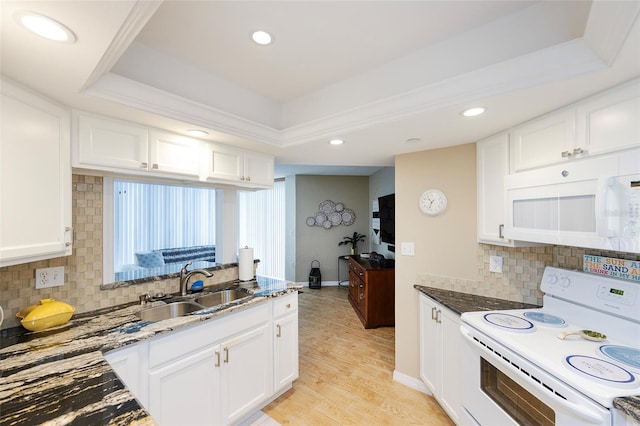 1 Oceans W Blvd Unit 1B5, Daytona Beach, FL 32118 - kitchen with white appliances, a raised ceiling, dark stone counters, white cabinetry, and recessed lighting
