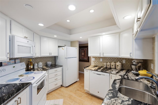 1 Oceans W Blvd Unit 1B5, Daytona Beach, FL 32118 - kitchen with white appliances, light wood finished floors, white cabinetry, backsplash, and recessed lighting
