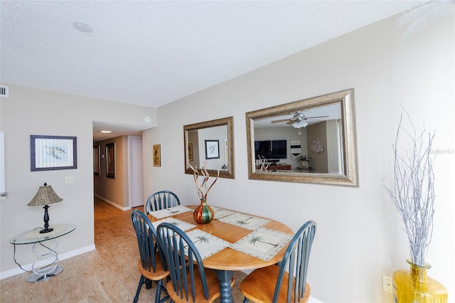 1 Oceans W Blvd Unit 1B5, Daytona Beach, FL 32118 - dining room with wood finished floors, a textured ceiling, and a ceiling fan