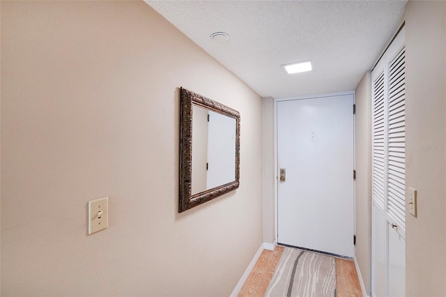 1 Oceans W Blvd Unit 1B5, Daytona Beach, FL 32118 - hall featuring light wood finished floors and a textured ceiling
