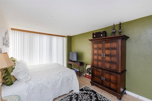 1 Oceans W Blvd Unit 1B5, Daytona Beach, FL 32118 - bedroom with light wood-type flooring and a textured wall